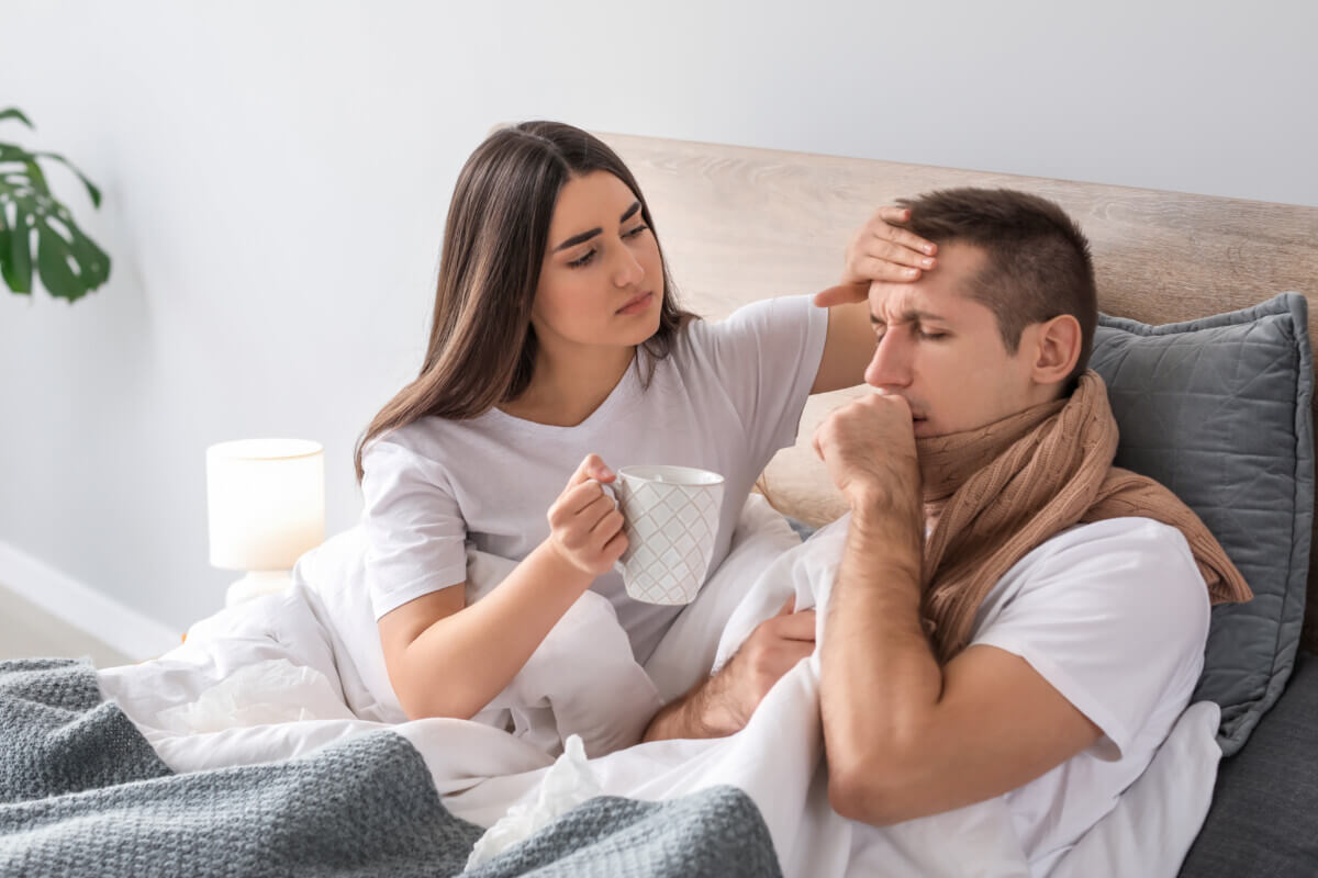 Woman taking care of husband ill with flu at home