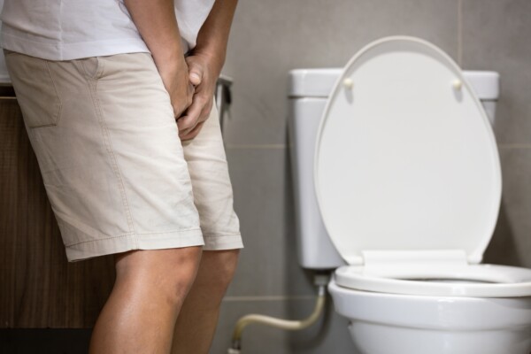 Man holding himself from overactive bladder or urinary tract infection