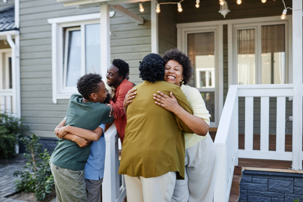 family embracing, welcoming guests