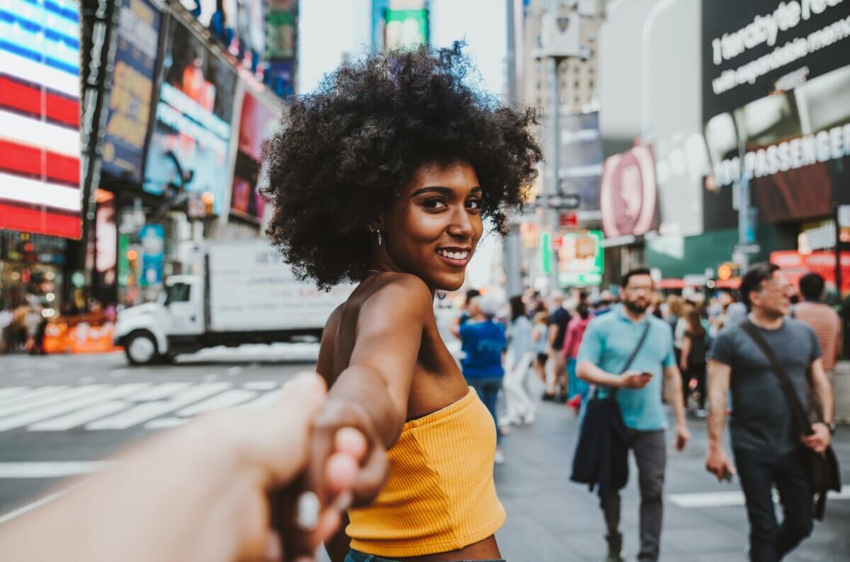 A woman leading someone through New York City