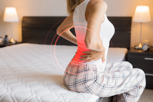 A woman with back pain from her mattress
