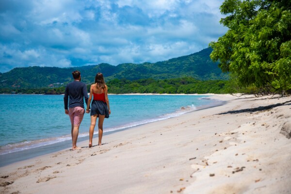 A couple walking on a beach in Costa Rica