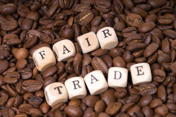 Fair-Trade spelled out in blocks over coffee beans