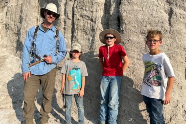 Denver Museum of Nature & Science's Curator of Paleontology Dr. Tyler Lyson and the trio of young fossil finders, Liam Fisher, Jessin Fisher, and Kaiden Madsen who discovered the remains of a juvenile T. rex skeleton while out looking for fossils with their dad Sam Fisher in North Dakota's bandlands in 2023.