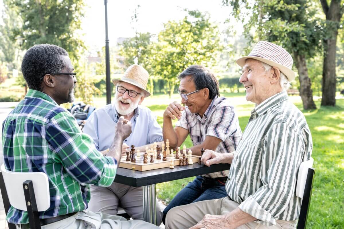 Group of senior friends playing chess
